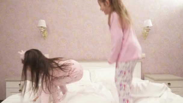 Little Cute Girls Jumping Bed Pink Pajamas — Stock Video