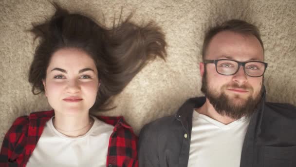Top View Happy Young Couple Lying Floor Looking Each Other — Vídeos de Stock
