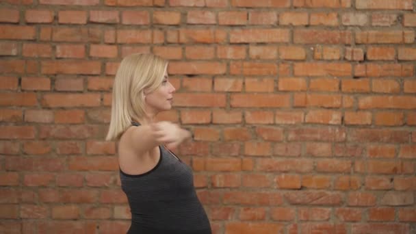 Side View Pregnant Blonde Dark Tank Top Stretching Her Hands — Stockvideo