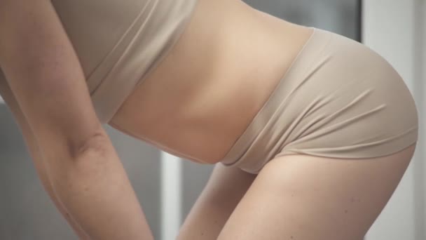 细长而适合女人的腹部的特写侧视图 然后她向前倾斜 开始把她的腹部吸进吸出 在家做瑜伽的女人 — 图库视频影像