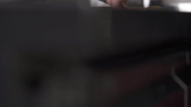 The bottom of the kitchen table, the camera moves bottom up and shows hands kneading a piece of dough on the table in the professional kitchen. Fresh noodles preparation in a restaurant