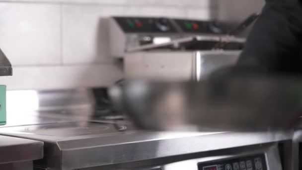 Hand Black Glove Puts Frying Pan Electric Stove Professional Kitchen — Video Stock