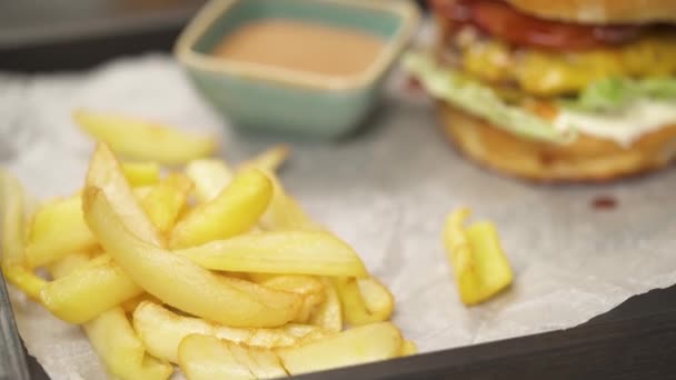 Close French Fries Tray Background Blurred Bit Camera Moves Right — Stockvideo
