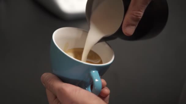 Hand Holding Light Blue Cup Coffee Another Hand Pouring Milk — Vídeo de Stock