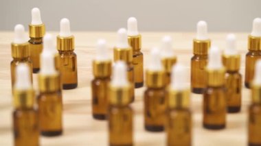 A close-up view of small amber bottles with white caps (focus changing)