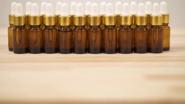 Close Front View Small Amber Bottles White Caps Arranged Two — стоковое видео