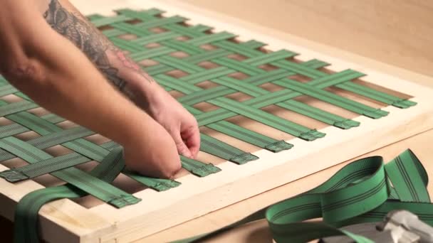 View Top Man Weaving Webbing Wooden Frame Attaching Wood Piece — Video