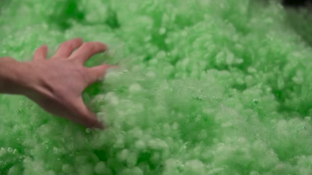 Close View Hand Touching Taking Green Polyester Fiberfill Black Background — Vídeo de stock