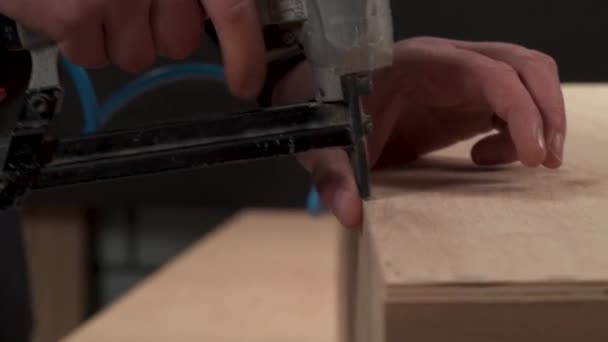 Close Man Hand Holding Pneumatic Staple Gun Stapling Plywood Board — Wideo stockowe