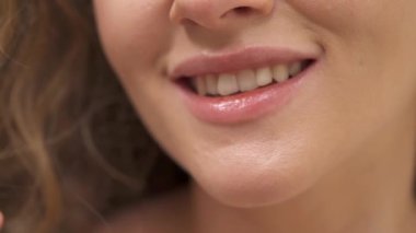 Close-up of charming wide smile of young woman with healthy white teeth. Isolated over white background