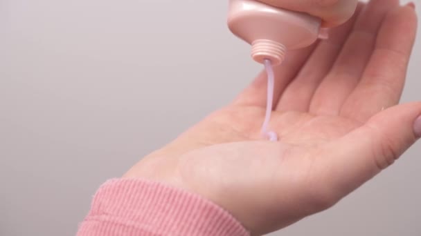 Hand Holding Cosmetic Pink Plastic Tube Squeezing Cream Hand — Stockvideo