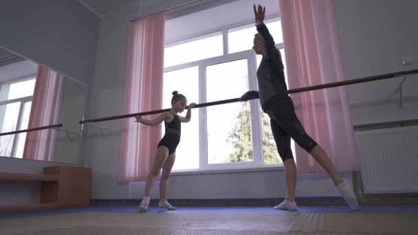 Young Gymnast Instructor Doing Gymnastic Exercises Wall Mounted Ballet Barre — kuvapankkivideo