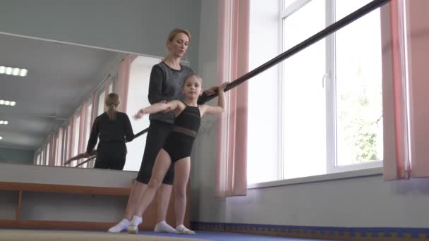 Little Gymnast Performing Gymnastic Exercises Wall Mounted Ballet Barre Instructor — Stock Video