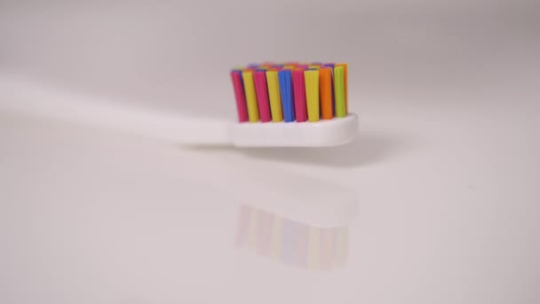 Bottom Top Shot Colorful Tooth Brush Tooth Paste Pouring White — Vídeo de Stock