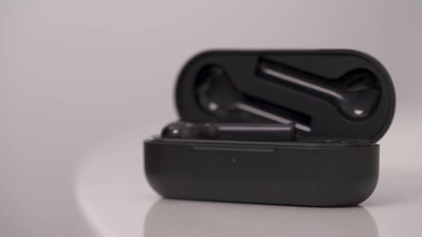 Black Wireless Headphones Isolated White Background Male Hand Putting Wireless — Stockvideo