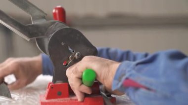 Özel ekipmanlarla birleşen işçilerin yakın çekimi. Plastik ambalaj ipinin uçları ahşap briketleri paketlemek için.