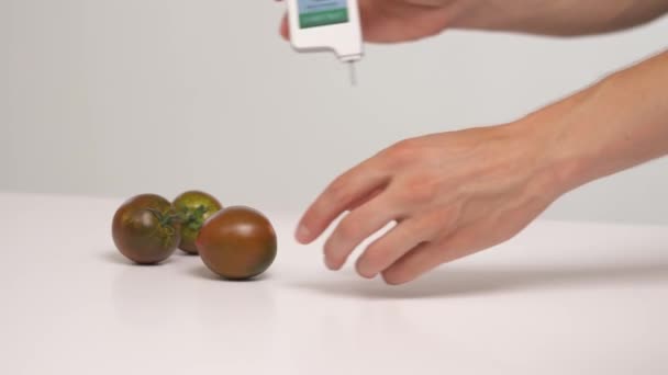 Zbliżenie Kilku Czarnych Pomidorów Białym Stole Tester Azotanów Analiza Chemiczna — Wideo stockowe