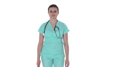 Kameraya gülümseyen ve ellerini ceplerine sokan güzel bir bayan doktorun yakın çekimi. Meslek kavramı, tıp ve sağlık, tıp eğitimi