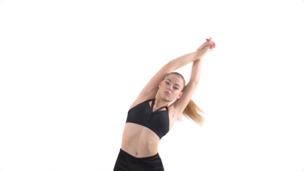 腹部回転を行う柔軟な女性フィットモデルのクローズアップ エアロビクスをやっている女性 ピラティス又はフィットネス要素 — ストック動画