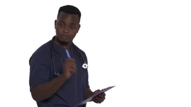 年轻的非洲裔美国医生站在一旁 持有病历填写病人数据的侧视图 在白色背景下孤立无援 — 图库视频影像