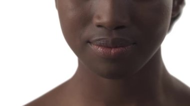 Beyaz arka planda gülümseyen genç Afrikalı kadın portresi