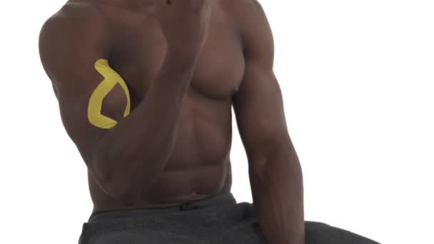 Close Unrecognizable Sportsman Having Kinesio Tape His Arm Demonstrating Biceps — Stock Video