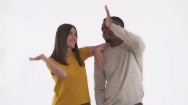 Kafkas kadın ve Afrikalı adamın beşlik çakışının portresi. Tokat el hareketi. Beyaz arkaplanda izole