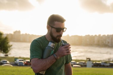 Uruguay 'da gün batımında bacarrao içen adam (sıcak suyla yerba eşinin bir karışımı).