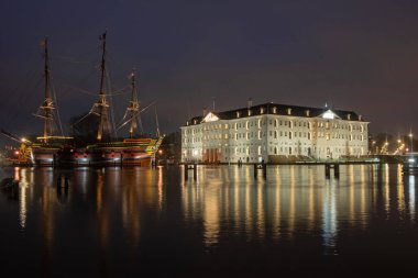 City scenic from Amsterdam harbor in the Netherlands at sunset