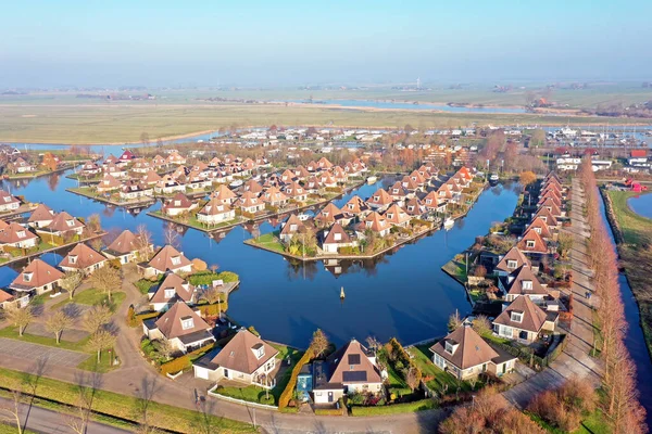 Aerial from a typical dutch landscape: houses and water in Friesland the Netherlands
