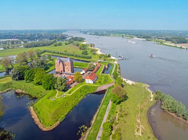 Aerial from shipping on the river Merwede with castle Loevestein in the Netherlands clipart