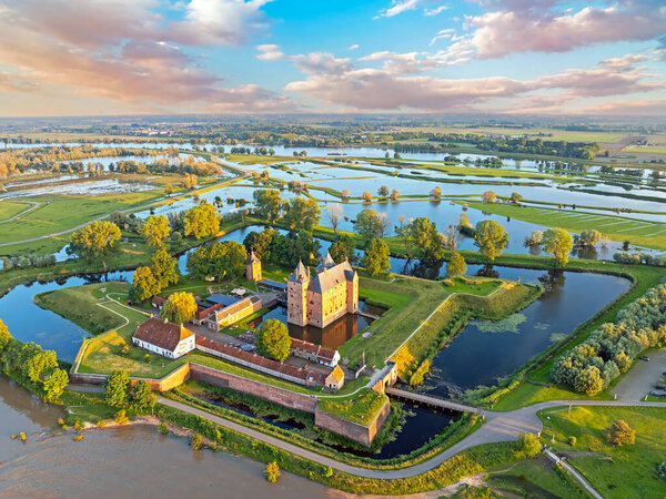 Aerial from a flooded landscape at castle Loevestein near Gorinchem in the Netherlands at sunset