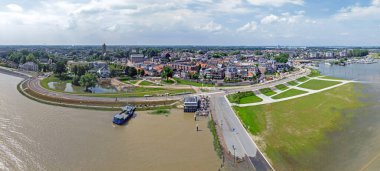 Aerial panorama from the town Tiel at the river Waal in a flooded landscape in the Netherlands clipart