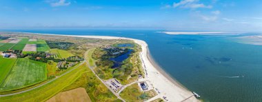 Aerial panorama from the north point of Texel island with the lighthouse in the Netherlands clipart