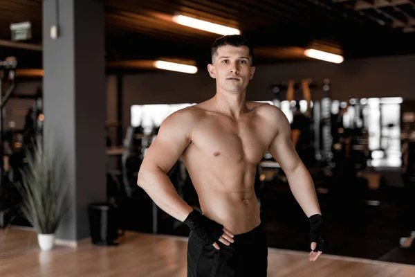 young bodybuilder and personal trainer working out in a modern, well-equipped gym. With determination and focus, the bodybuilder engages in various exercises, showcasing strength and athleticism. The