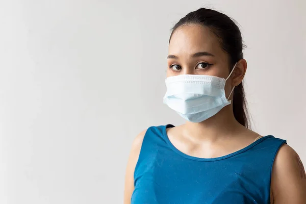 stock image Woman wearing protective face mask for seasonal flu and dust pollution protection