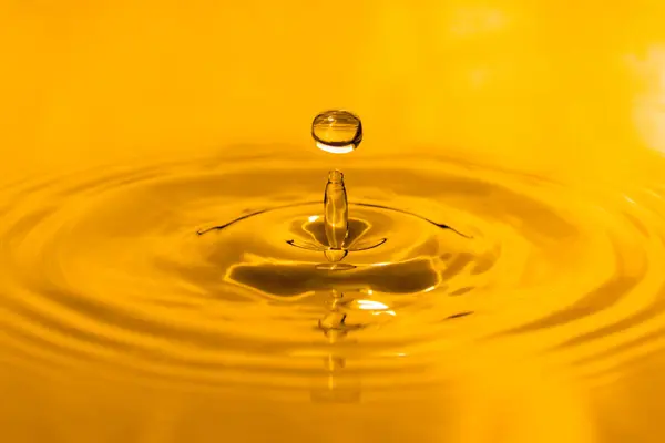 yellow drop oil , Liquid gold oil drop ripple background