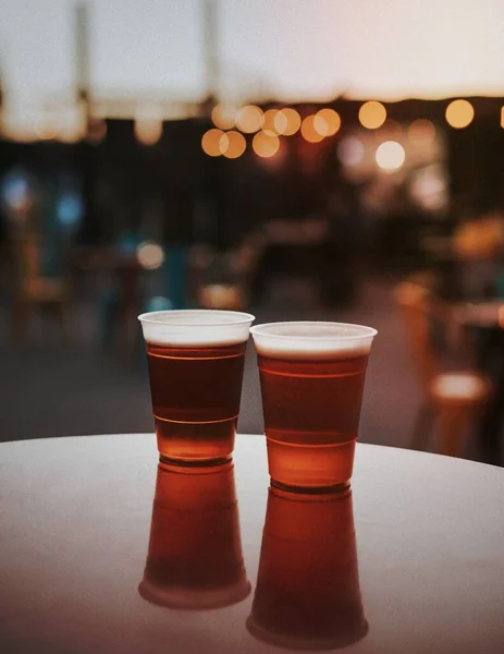 Two plastic cups with beer