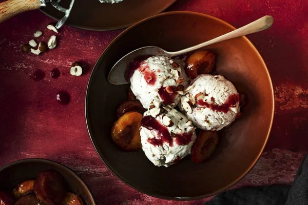 Roasted plums ice cream bowl with spoon