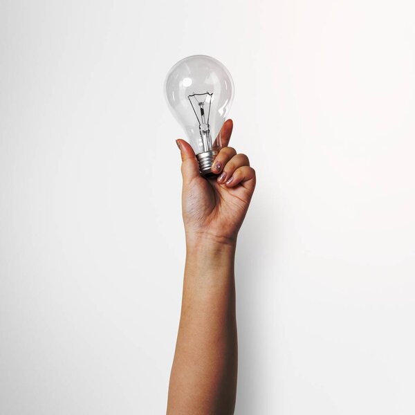 Light bulb creative business idea symbol held by a hand