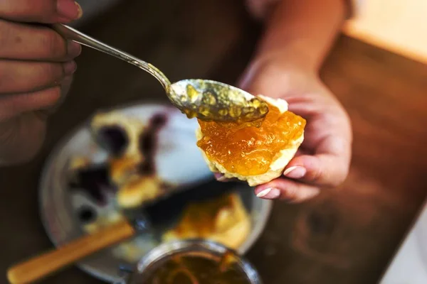 stock image Spoonful of citrus jam on a piece of scone