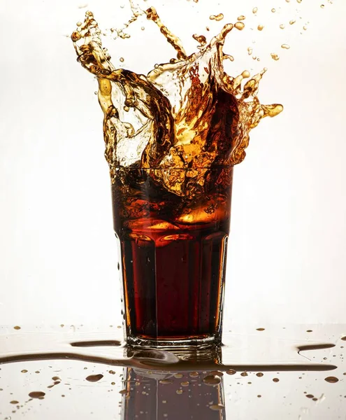 stock image Cold carbonated drink splashing over the glass 