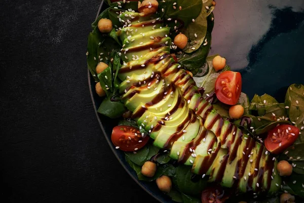 salad with avocado, nuts, tomatoes and sauce