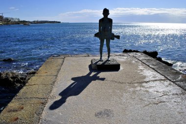 A child holding a fish statue
