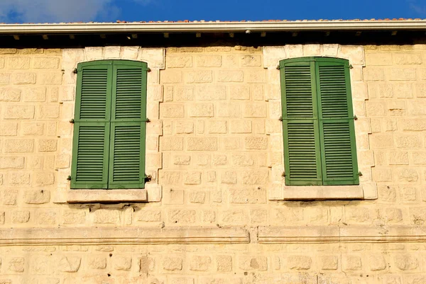 An old green windows at stone house in Cyprus