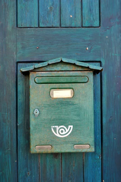 Green mailbox on the door