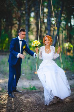 Mavi takım elbiseli, beyaz elbiseli ve buketli güzel bir çift.