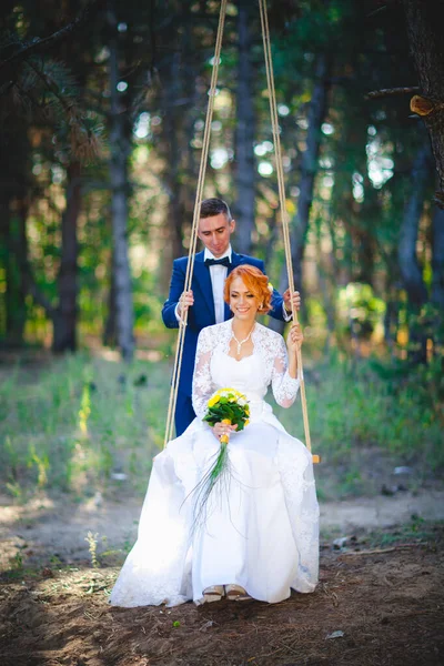 Mavi takım elbiseli, beyaz elbiseli ve buketli güzel bir çift.