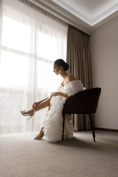 아침에 잠옷과 란제리의 고급스러운 방에서 호텔에서 고급스럽고 아름다운 신부를위한 신발과 로열티 프리 스톡 사진