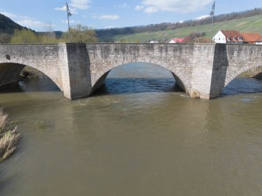 Ingelfingen yakınlarındaki Kocher nehri üzerindeki taş kemer köprüsü, insansız hava aracı atışı, Almanya